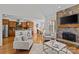 Open living room with stone fireplace, wood floors, and views into the kitchen and dining area at 2464 Chatham Dr, Indian Land, SC 29707