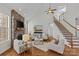 Bright living room with hardwood floors, stone fireplace, and comfortable seating at 2464 Chatham Dr, Indian Land, SC 29707