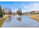 Scenic pond with fountain and view of houses, offers a peaceful community setting at 2464 Chatham Dr, Indian Land, SC 29707