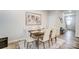 The dining room has a dark wood table, cream chairs, light hardwood floors and a neutral-colored rug at 296 Laura Elizabeth Ln, Clover, SC 29710