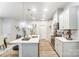 Open kitchen with stainless steel appliances, quartz countertops, large island with seating, and hardwood floors at 296 Laura Elizabeth Ln, Clover, SC 29710