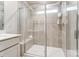 Sleek glass-enclosed shower with tiled walls, a built-in seat, and ample natural light at 296 Laura Elizabeth Ln, Clover, SC 29710