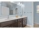 Light and bright bathroom featuring a double sink with updated countertops and flooring at 3907 Reid Cir, Sherrills Ford, NC 28673