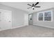 Bedroom features carpet flooring, two windows for natural light, closet, and ceiling fan at 3924 13Th Ne St, Hickory, NC 28601