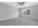 Bright bedroom with neutral walls, carpet floors, ceiling fan, and a large window at 3924 13Th Ne St, Hickory, NC 28601