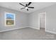 Bedroom with large window and closet that includes a ceiling fan and soft carpet at 3924 13Th Ne St, Hickory, NC 28601