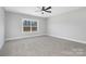 Bedroom featuring carpet, a ceiling fan and a large window that provides natural light at 3924 13Th Ne St, Hickory, NC 28601