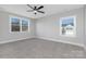 Spacious bedroom with neutral walls, carpet floors, a ceiling fan and natural light from two windows at 3924 13Th Ne St, Hickory, NC 28601