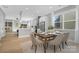 Dining room leading to kitchen featuring an elegant table setting, with large sunny windows at 3924 13Th Ne St, Hickory, NC 28601