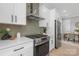 Modern kitchen boasts stainless steel appliances and white cabinets with long black handles at 3924 13Th Ne St, Hickory, NC 28601