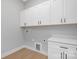 Bright laundry room with white cabinets, countertop, and vinyl floors at 3924 13Th Ne St, Hickory, NC 28601