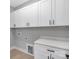 Bright laundry room featuring white cabinets, countertop, and vinyl floors at 3924 13Th Ne St, Hickory, NC 28601