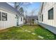 Backyard featuring a grassy area with stone path, white siding and blue door at 416 E 18Th St, Charlotte, NC 28206