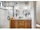 Bright bathroom featuring double sink vanity, granite countertop, wooden cabinets and glass enclosed shower with contrasting tile at 416 E 18Th St, Charlotte, NC 28206