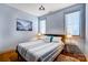 Bedroom with neutral color scheme, two windows, a queen sized bed and stylish side tables with lamps at 416 E 18Th St, Charlotte, NC 28206