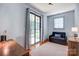 Bright room with sliding glass doors to the yard, a cozy sofa, desk and plush area rug at 416 E 18Th St, Charlotte, NC 28206