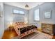 Bright bedroom features two windows, a metal bed frame, patterned bedding, and decorative furniture at 416 E 18Th St, Charlotte, NC 28206