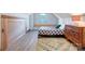 Bright bedroom with a patterned rug, wood floors, and a built-in bed against the wall at 416 E 18Th St, Charlotte, NC 28206