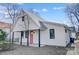 This home offers a modern design with a light gray metal roof, black trim, and a coral-colored front door at 416 E 18Th St, Charlotte, NC 28206