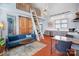 Inviting living area showcasing high ceilings, a modern chandelier, and access to a loft area via a stylish ladder at 416 E 18Th St, Charlotte, NC 28206