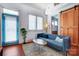 Comfortable living room featuring a cozy couch, stylish coffee table, and a bright blue exterior door at 416 E 18Th St, Charlotte, NC 28206