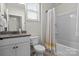 Cozy bathroom with granite vanity, white toilet, and shower/tub combo with yellow and white curtain at 4288 Legacy Dr, Denver, NC 28037