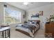 Inviting bedroom with large window, wooden dresser, and unique decor at 4288 Legacy Dr, Denver, NC 28037