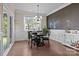 Bright dining room with black table and chairs, with chalk wall and sliding door to the patio at 4288 Legacy Dr, Denver, NC 28037