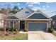 Inviting home showcasing stone accents, blue siding, and a well-manicured lawn at 4288 Legacy Dr, Denver, NC 28037