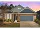 Charming home featuring a stone and siding exterior, complemented by a two-car garage and manicured landscaping at 4288 Legacy Dr, Denver, NC 28037