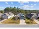 Home exterior featuring a manicured lawn, stone accents, and a two-car garage at 4288 Legacy Dr, Denver, NC 28037