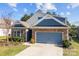 Attractive home featuring stone detailing, blue siding, and an attached two-car garage at 4288 Legacy Dr, Denver, NC 28037