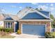 Attractive home featuring stone detailing, blue siding, and an attached two-car garage at 4288 Legacy Dr, Denver, NC 28037