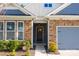 Charming home exterior with stone accents, blue siding, and a gray garage door at 4288 Legacy Dr, Denver, NC 28037