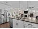 Spacious kitchen island with granite countertop, stainless steel appliances, and open floor plan at 4288 Legacy Dr, Denver, NC 28037