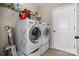 This spacious laundry room includes a modern washer and dryer and wire shelving for storage at 4288 Legacy Dr, Denver, NC 28037