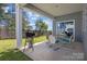 Covered patio with outdoor seating, grill, and view of the landscaped backyard at 4288 Legacy Dr, Denver, NC 28037