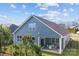 Rear view of a blue home with a patio and outdoor table and chairs at 4288 Legacy Dr, Denver, NC 28037