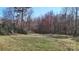 Backyard with a grass field and tall trees at 4774 E Nc 150 Hwy, Lincolnton, NC 28092