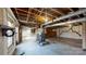 Unfinished basement with exposed ceiling beams, concrete floors, and wood-burning stove at 4774 E Nc 150 Hwy, Lincolnton, NC 28092