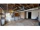 Unfinished basement with exposed ceiling, concrete floors, and an old wood burning stove at 4774 E Nc 150 Hwy, Lincolnton, NC 28092