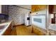 Kitchen featuring vintage appliances, floral wallpaper and wood cabinets at 4774 E Nc 150 Hwy, Lincolnton, NC 28092