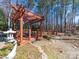 Backyard wooden pergola feature with mature landscaping in wooded area at 549 Briarwood Ln, Lancaster, SC 29720