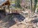 Outdoor patio with a bridge over a rock feature leading to a fire pit seating area, perfect for entertaining at 549 Briarwood Ln, Lancaster, SC 29720