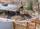 Expansive backyard featuring covered patio, stone fireplace, outdoor seating, and wooden bridge at 549 Briarwood Ln, Lancaster, SC 29720