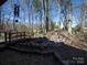 Backyard landscape with a wooden bridge and rock features at 549 Briarwood Ln, Lancaster, SC 29720