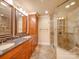 Bathroom featuring double sink vanity, a glass-enclosed shower with stone-look tile at 549 Briarwood Ln, Lancaster, SC 29720