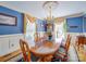 Formal dining room with blue walls, chandelier, and elegant wood table set at 549 Briarwood Ln, Lancaster, SC 29720