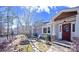 Charming front entrance featuring a cozy stone patio, red door, and serene outdoor seating area at 549 Briarwood Ln, Lancaster, SC 29720