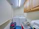 Functional laundry room features side by side washer and dryer with cabinet storage at 549 Briarwood Ln, Lancaster, SC 29720